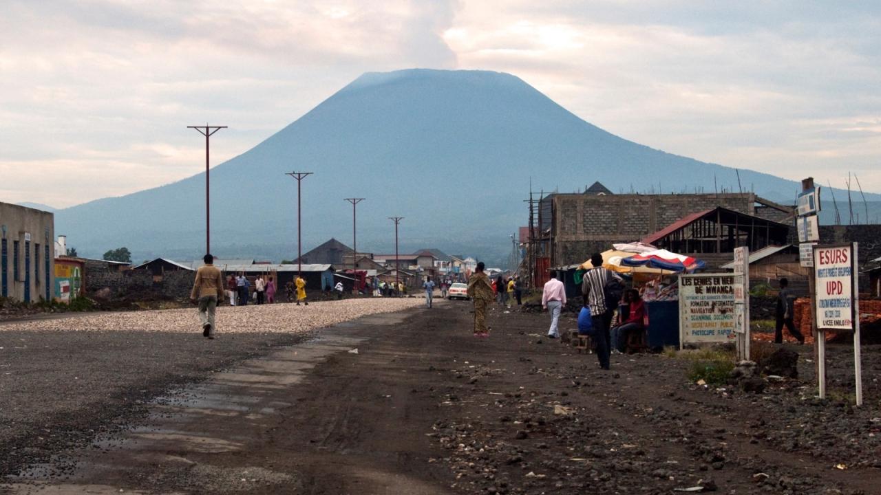 Residents walk an unpaved road in eastern Democratic Republic of Congo
