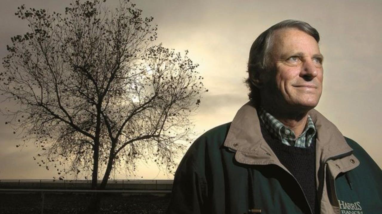 John Harris stands in front of a tree.