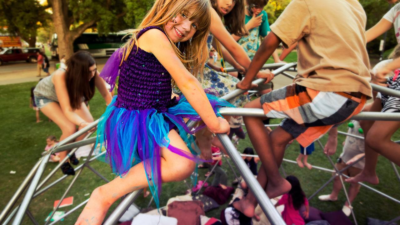 Children climb on a dome during the Whole Earth Festival.