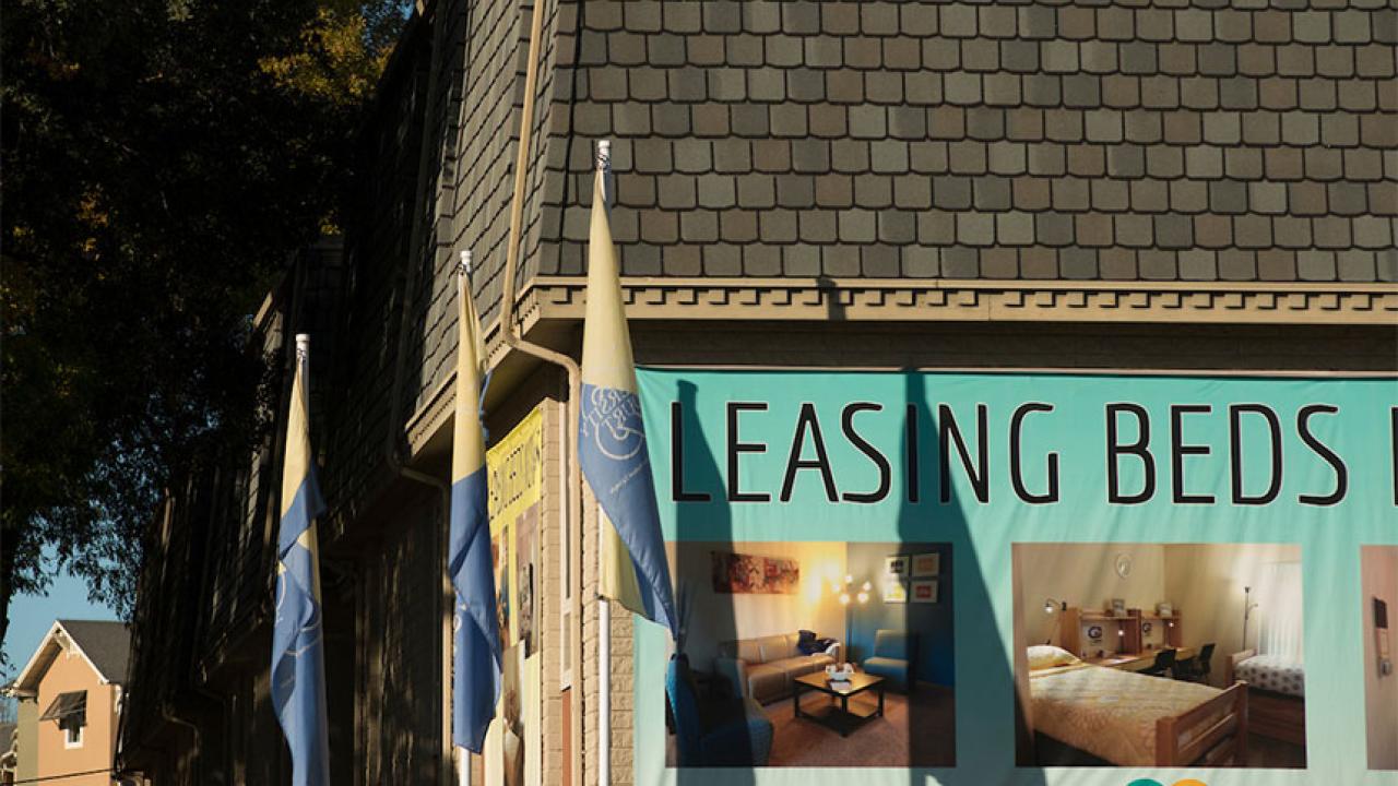 Apartment building with signs offering leases