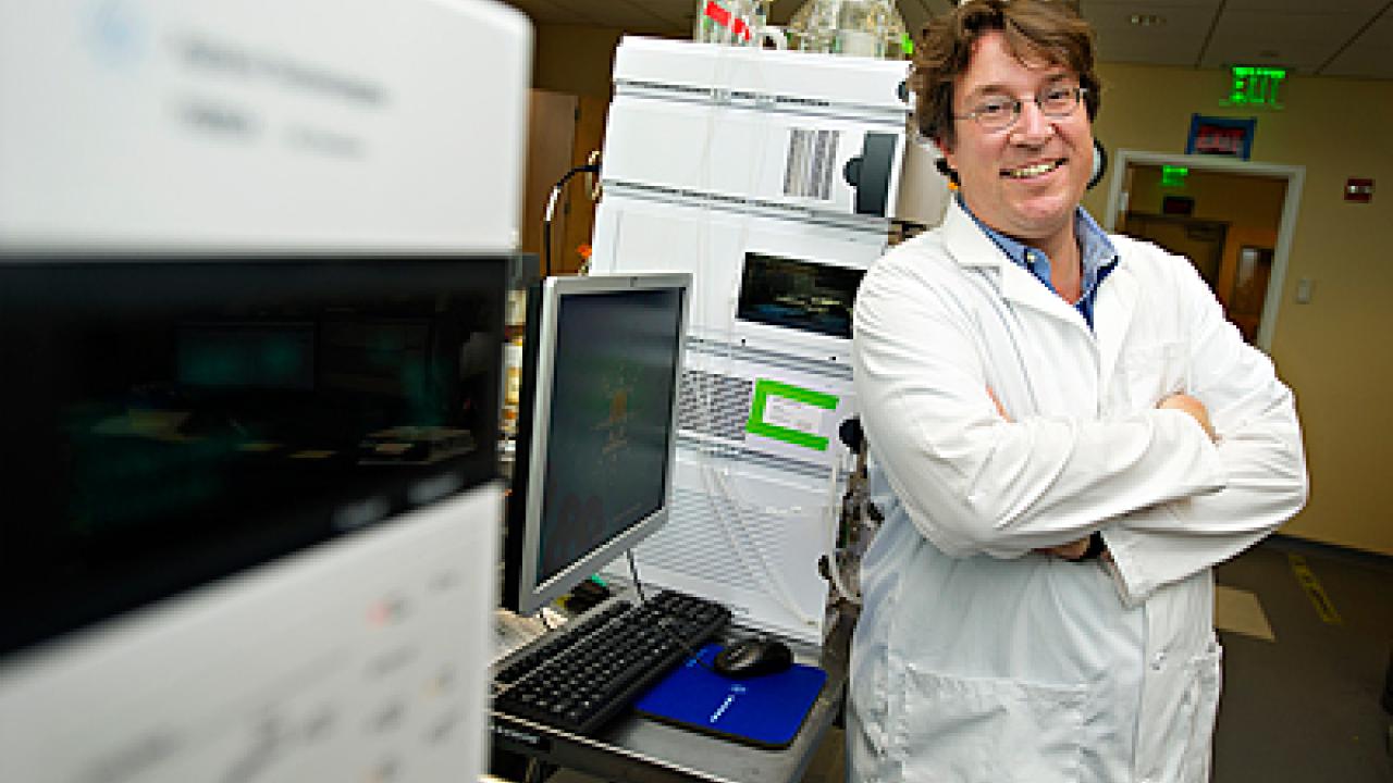 Oliver Fiehn standing in lab with equipment.