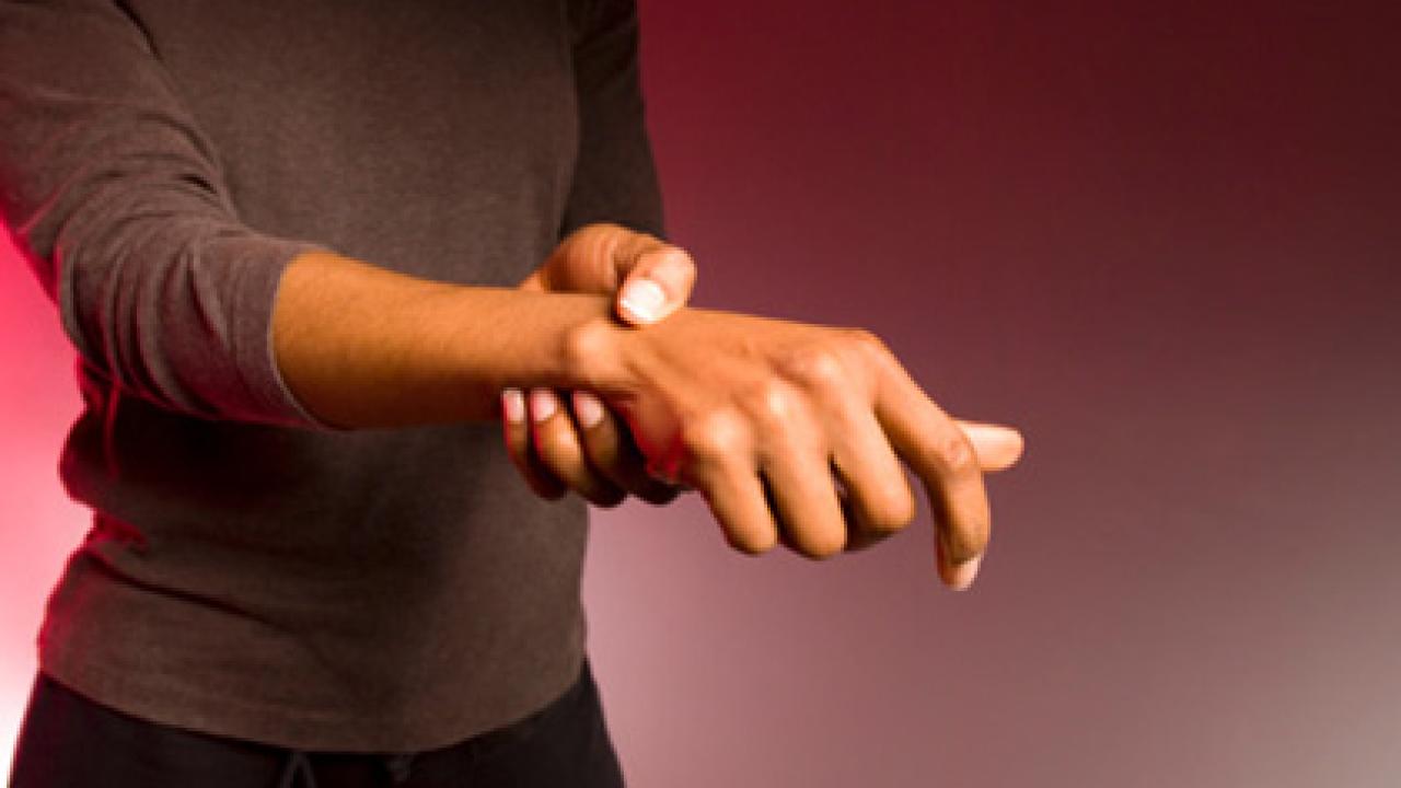 Woman holding her wrist