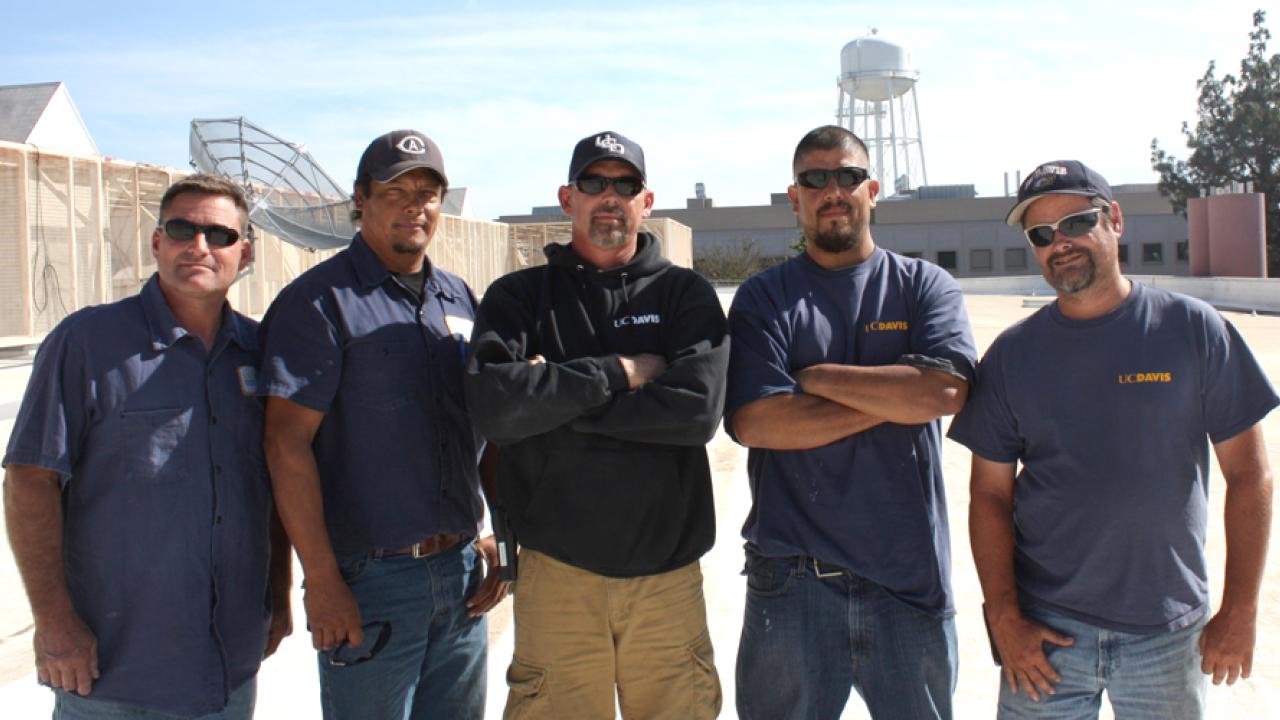 Photo: Campus roofing crew on top of building.