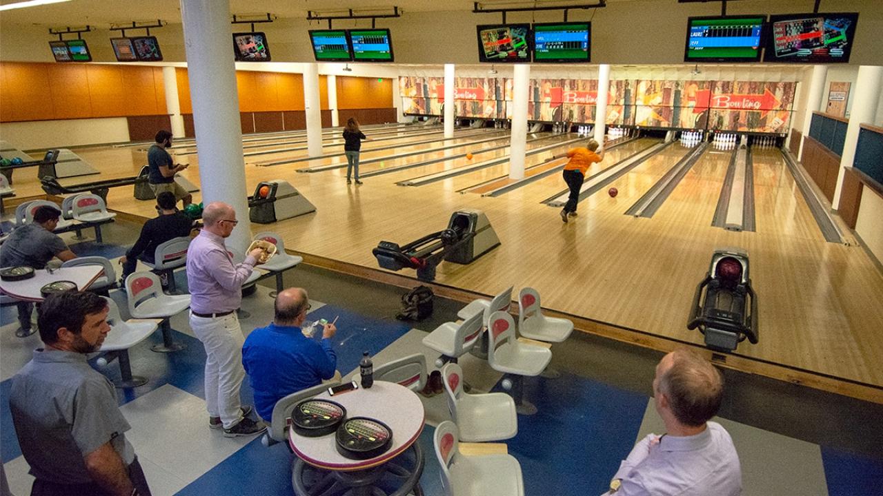 Staff members bowl in the Memorial Union Games Area.