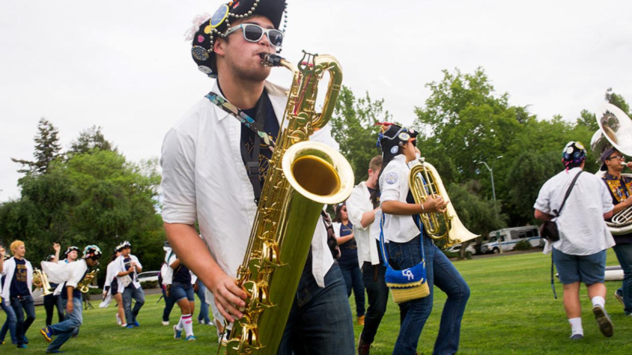 The Cal Aggie Marching Band-uh! plays on Russell Field.