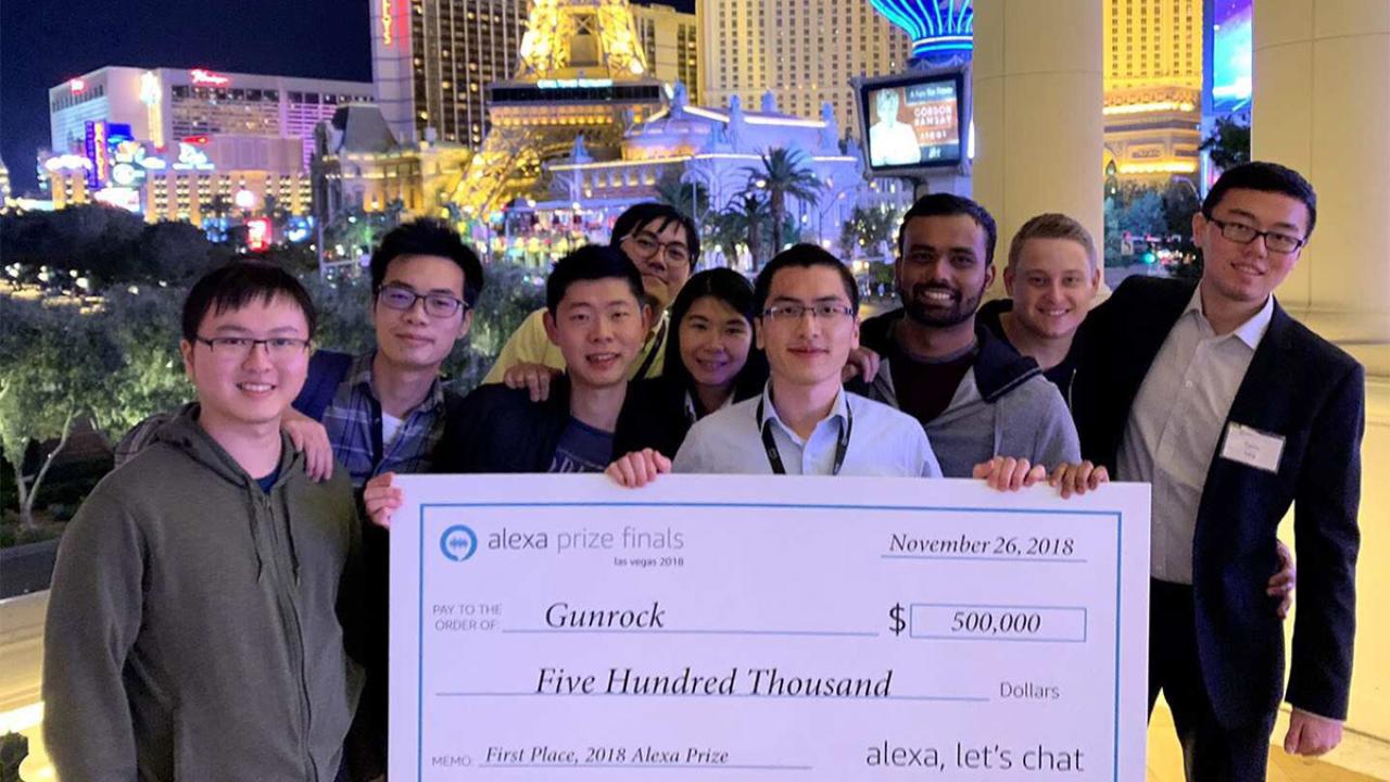 Students pose with a $500,000 check in Las Vegas.