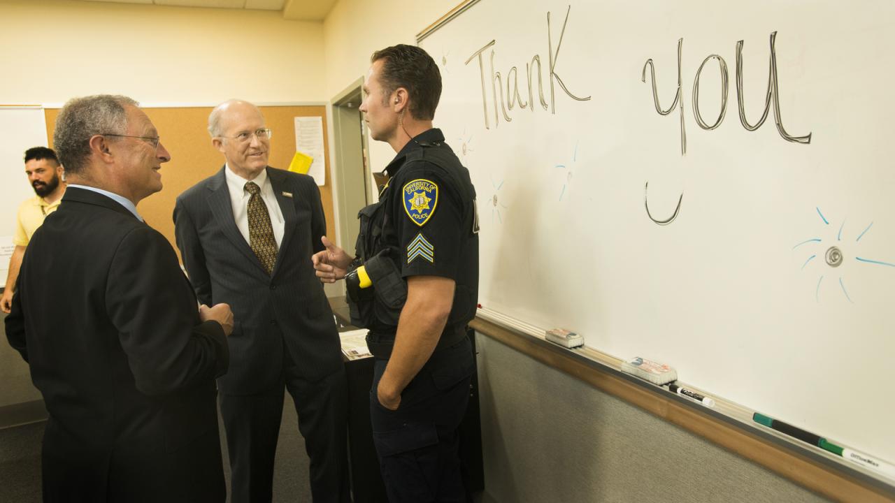 Acting Chancellor Ralph J. Hexter and Acting Provost Ken Burtis speak with Sgt. Max Thomas.