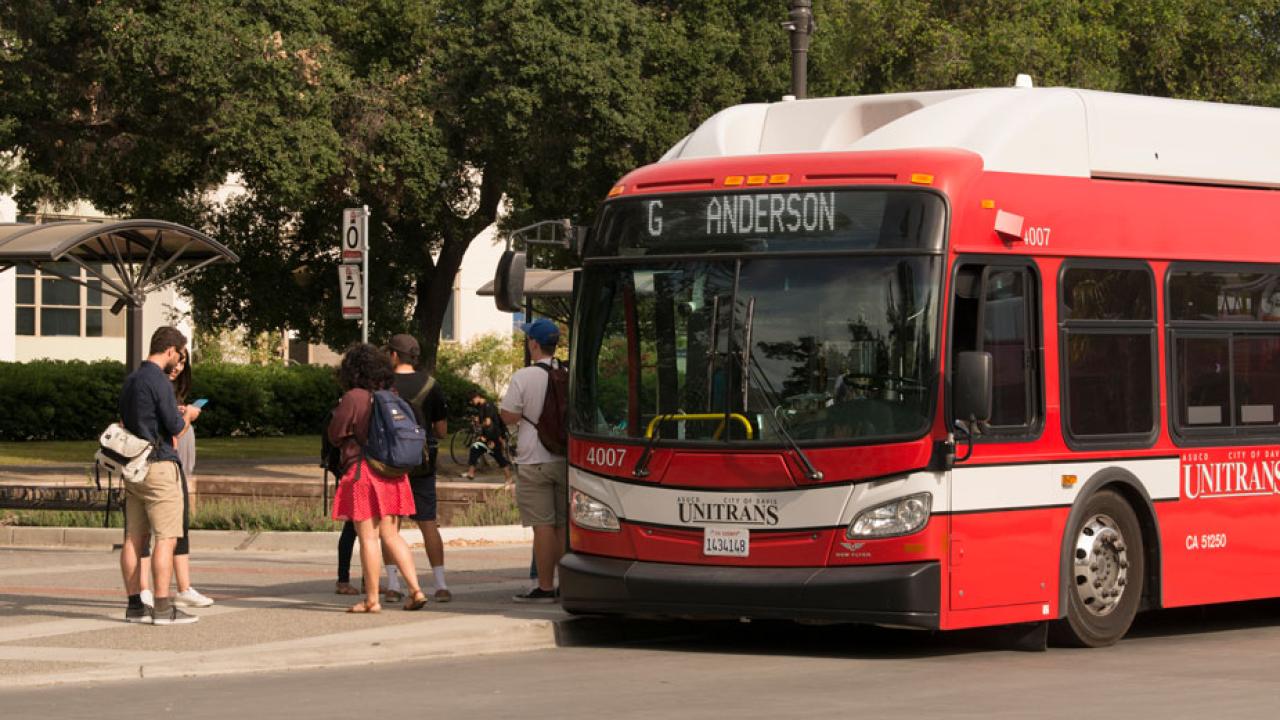 People board a Unitrans bus.