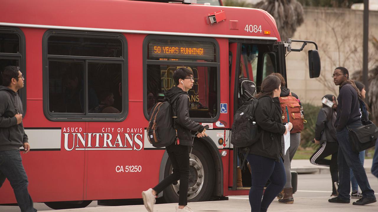 Students board a Unitrans bus.