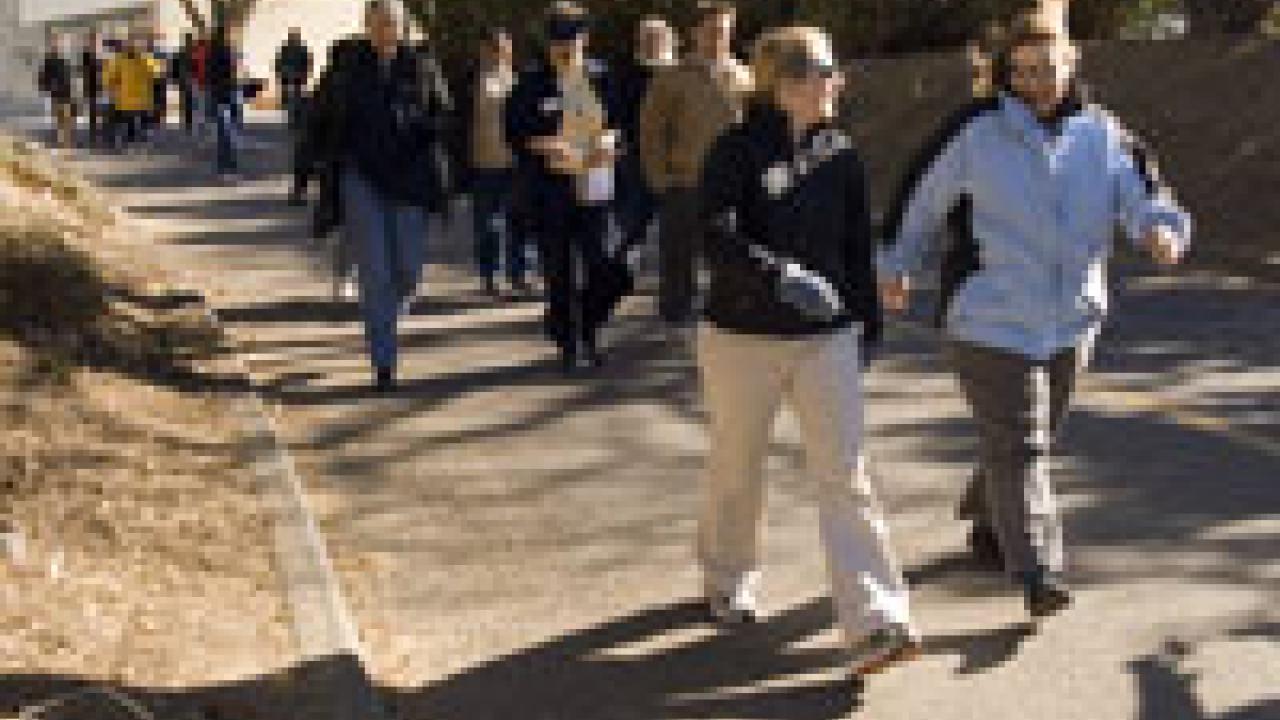 Nearly two dozen people set out on a group walk with Provost Virginia
Hingham, center in the second row, as part of the Winter Walkabout sponsored by Aggie On the Move on Jan. 17. The walk began in the ARC, where the provost gave a short pep ta