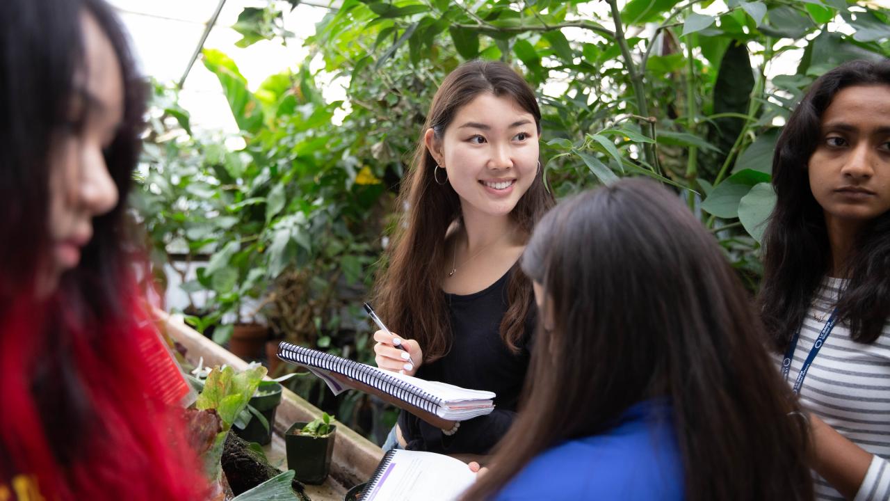 students taking notes in garden