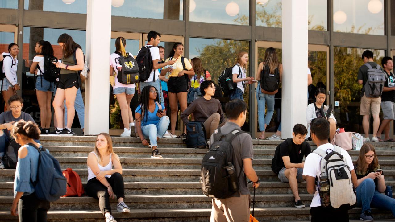 Students come and go and hang out on steps of Rock Hall.