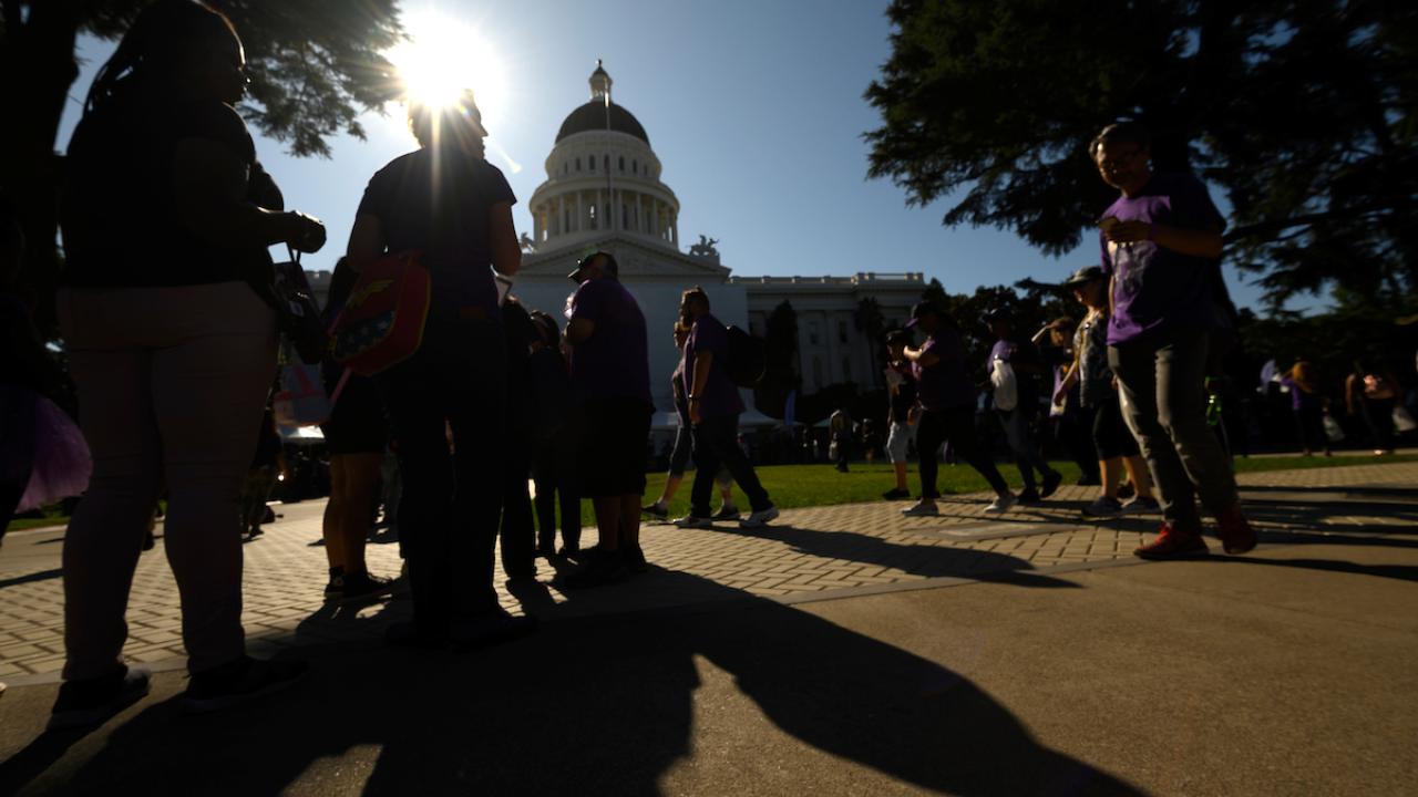 Protesters in shadows at California capitol building in Sacramento