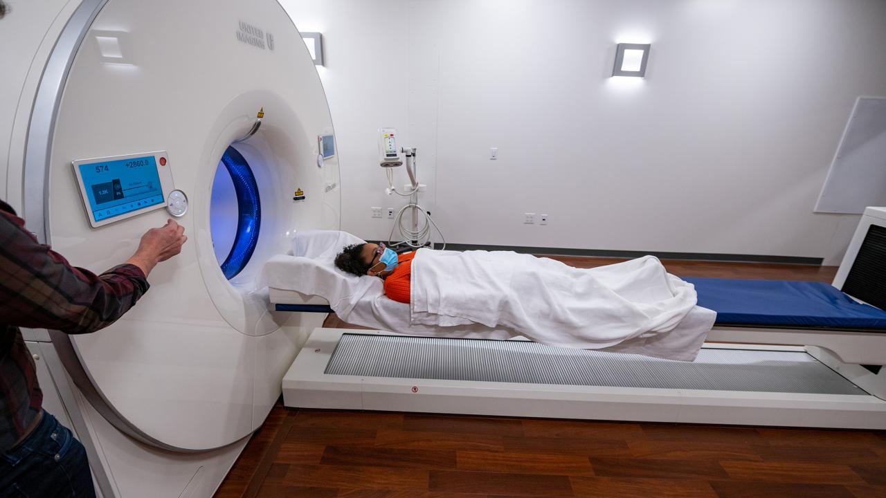 Person lying on table about to enter medical scanner