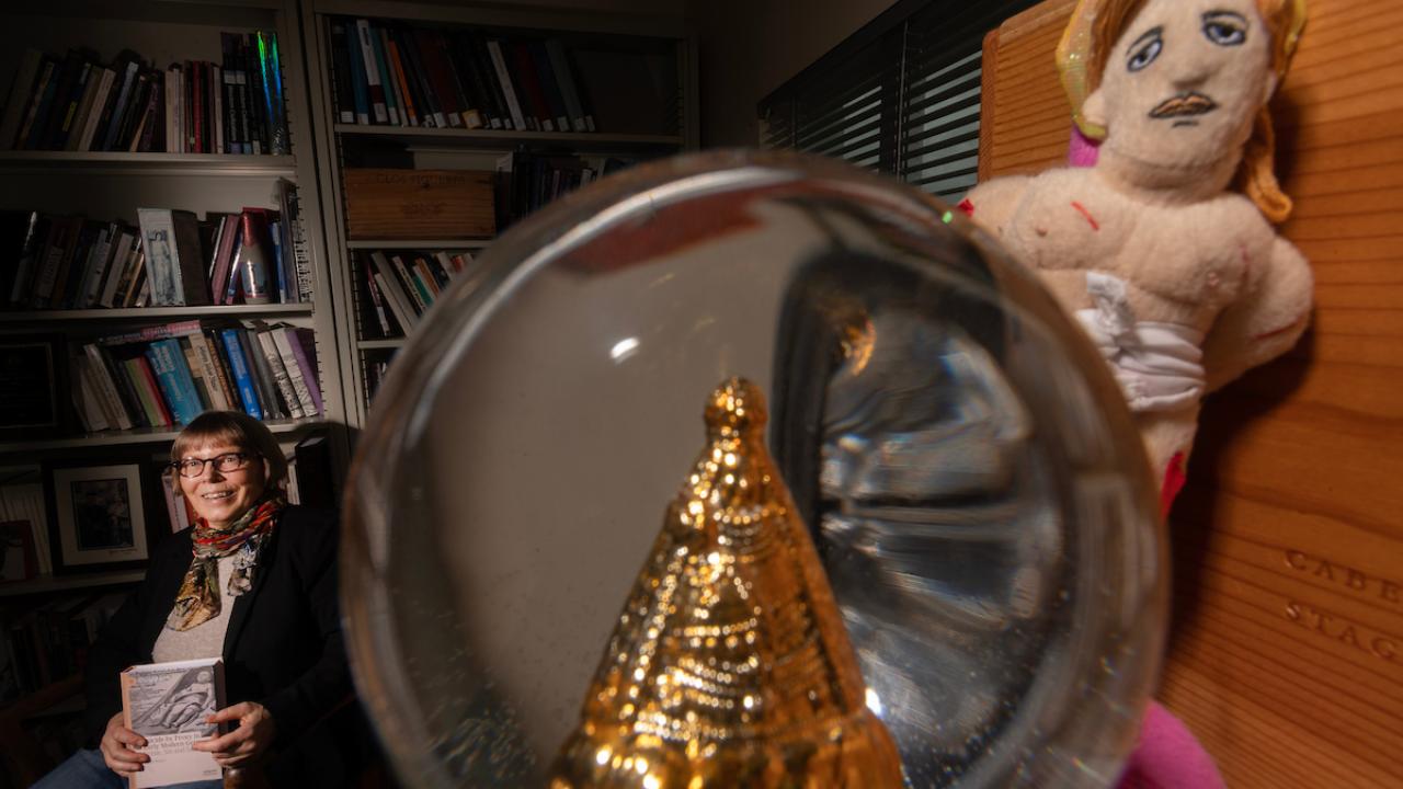 Woman in background of office space with objects in front 