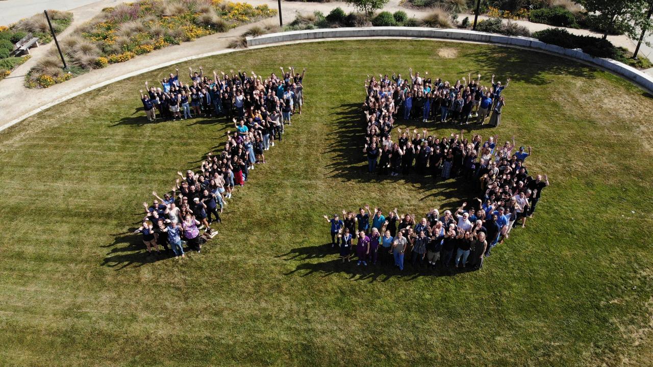 View from above with people spelling out 7-5 on the grass