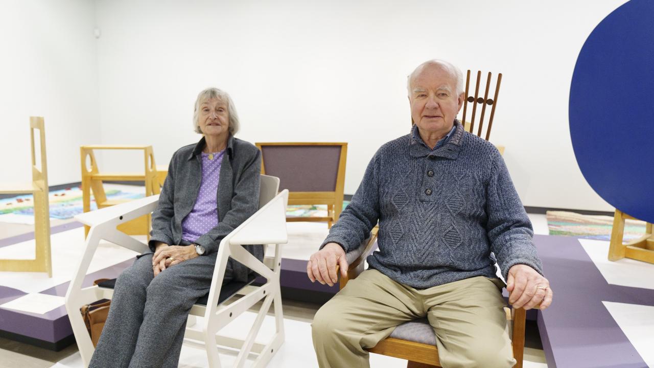 Older couple sitting in light wooden furniture