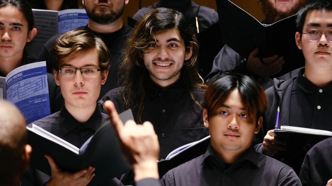 Choir on stage, dressed in black