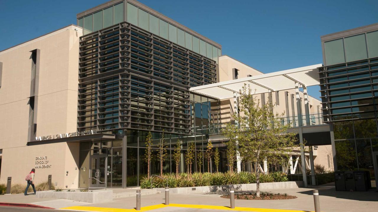 Student walks toward Maurice J. Gallagher Hall at UC Davis