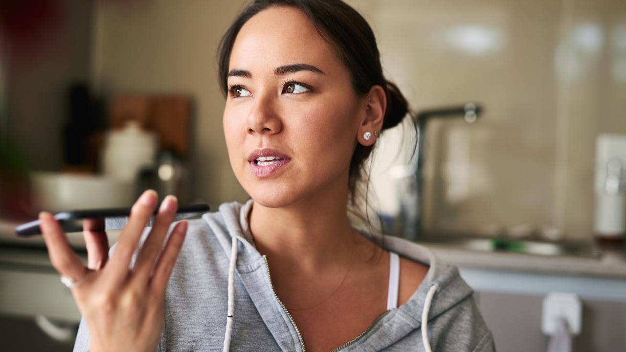 Woman talking to her Siri-based device. UC Davis researchers find that most of us speak differently when talking to voice AI. (Getty)