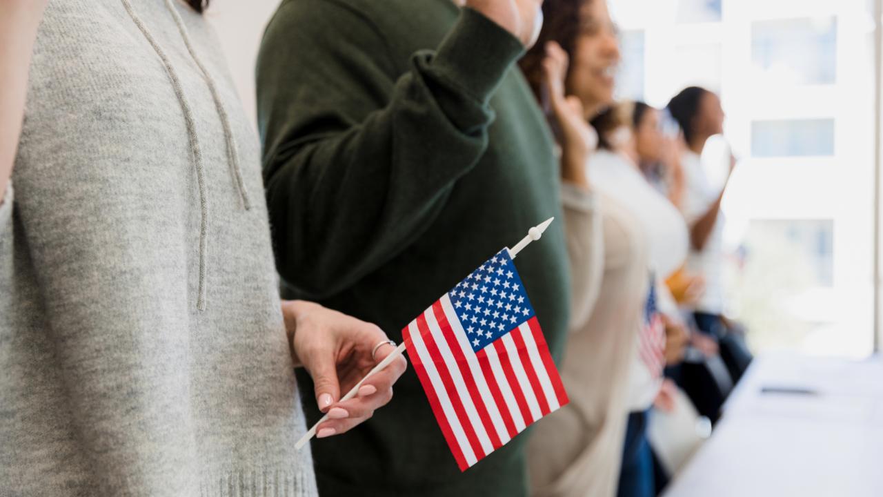 People holding American flags at citizenship ceremony