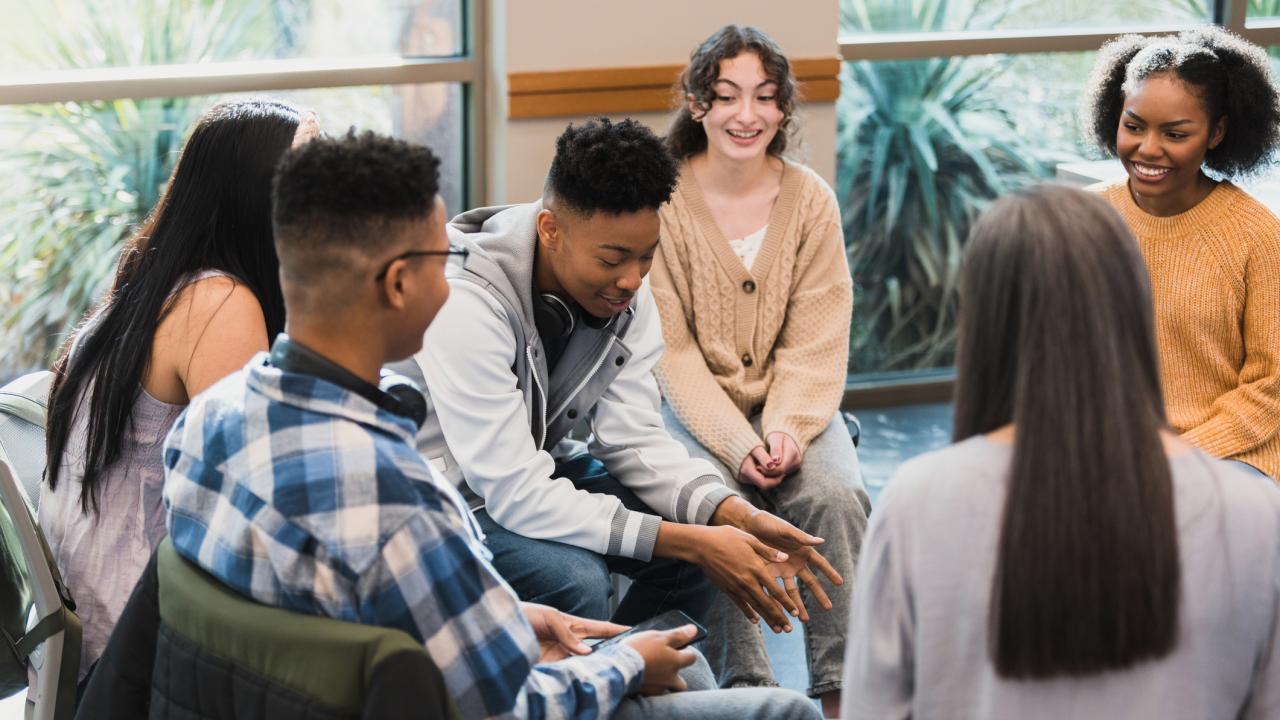 Adolescents in school setting having discussion