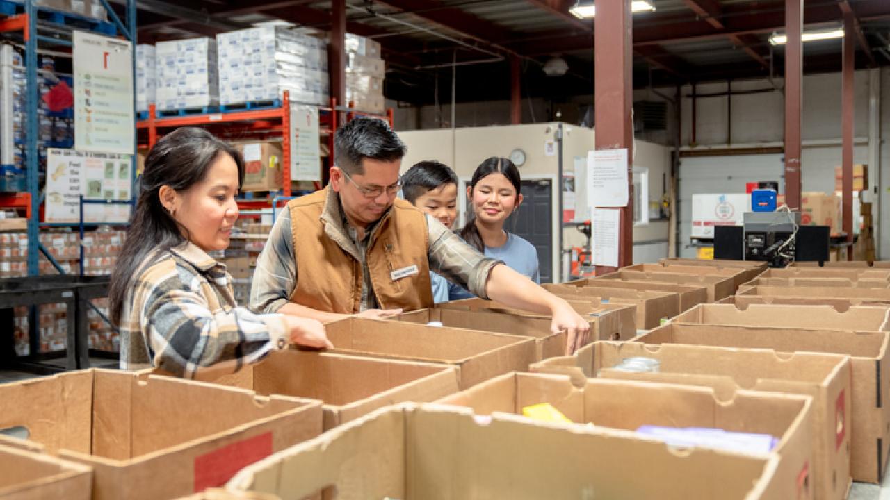 UC Davis researchers have developed a way for food banks to evaluate the way they promote nutrition and healthy. Here, people load food donations into cardboard boxes in a warehouse. (Getty Images)