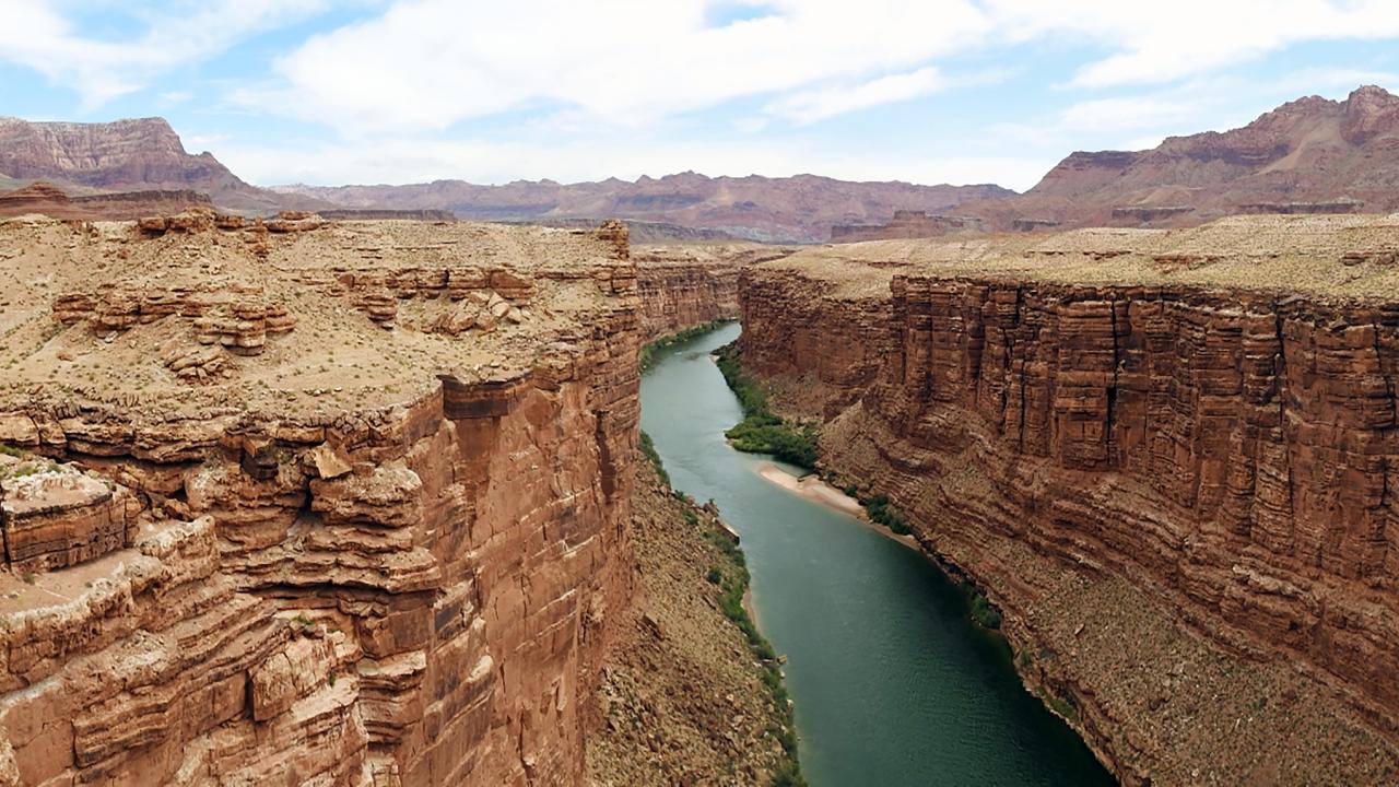 Aerial of Colorado River running through sandtone canyon 