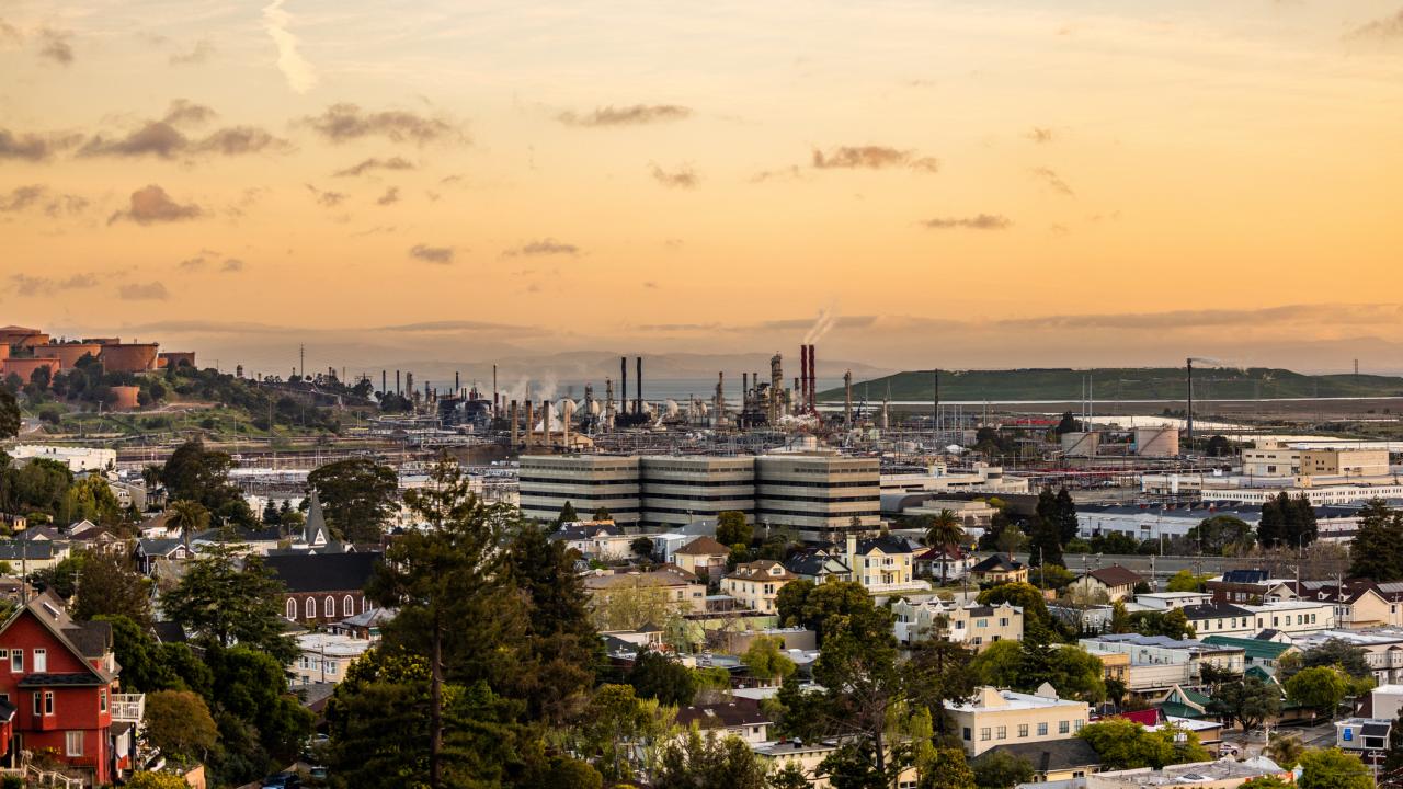 Skyliine of Richmond, California showing homes, businesses and oil and gas refinery 