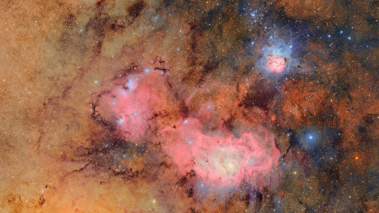 Clouds of yellow and pink scattered with bright white stars