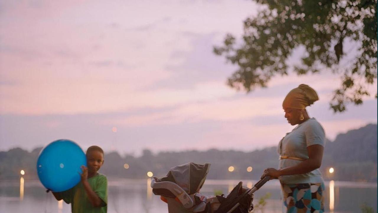 Image of woman pushing stroller and child