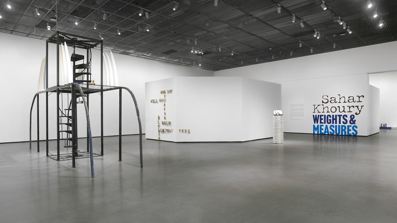 Installation view of tall sculpture with spiral staircase