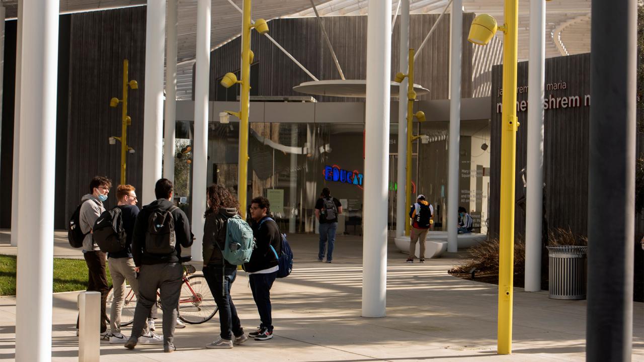 Students talk together outside the Jan Shrem and Maria Manetti Shrem Museum of Art 