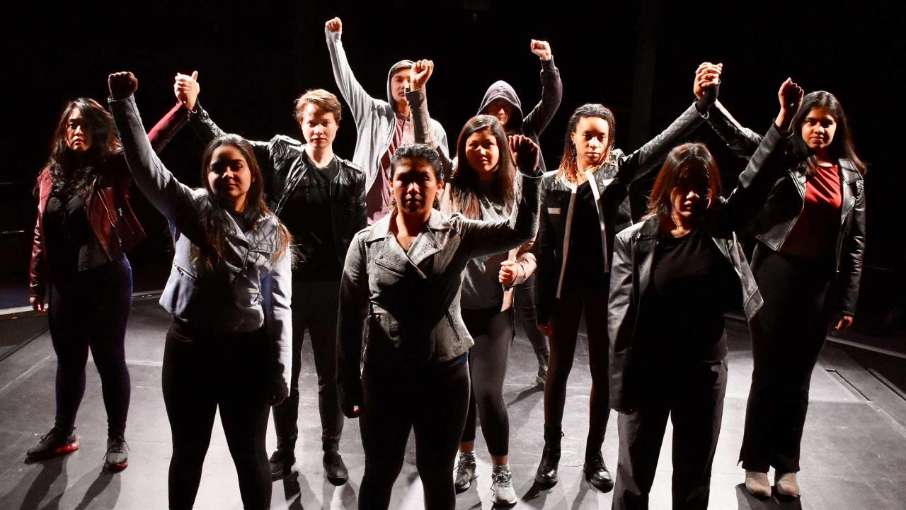 Student actors looking happy on stage