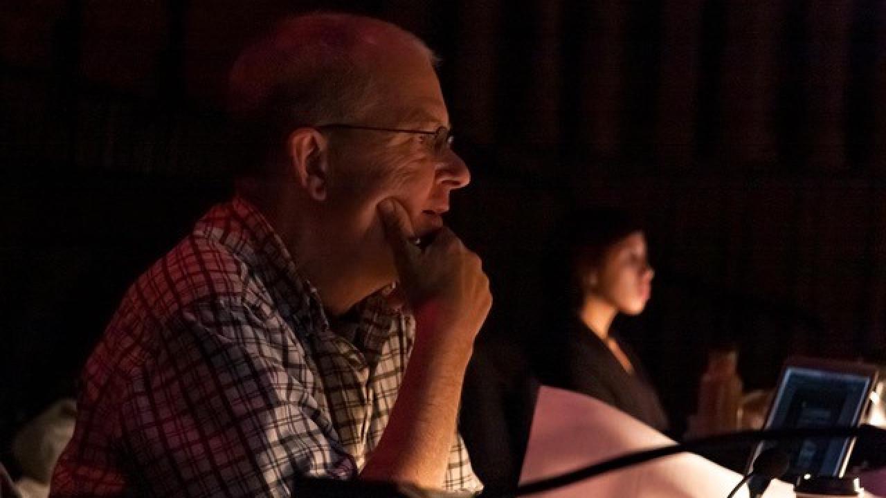 Tom Munn sitting at a desk at technical rehearsal for Tilly NoBody
