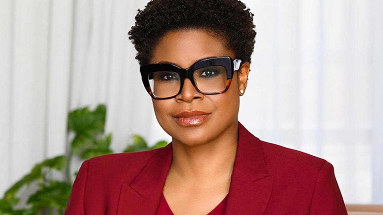 Woman in glasses shown shoulders up