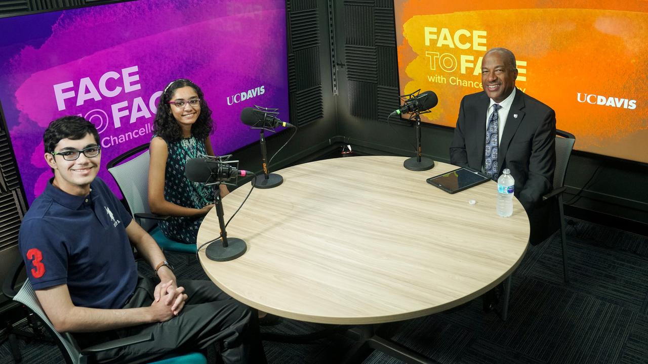 Tanishq and Tiara Abraham sitting with Chancellor Gary S. May on the set of Face to Face With Chancellor May