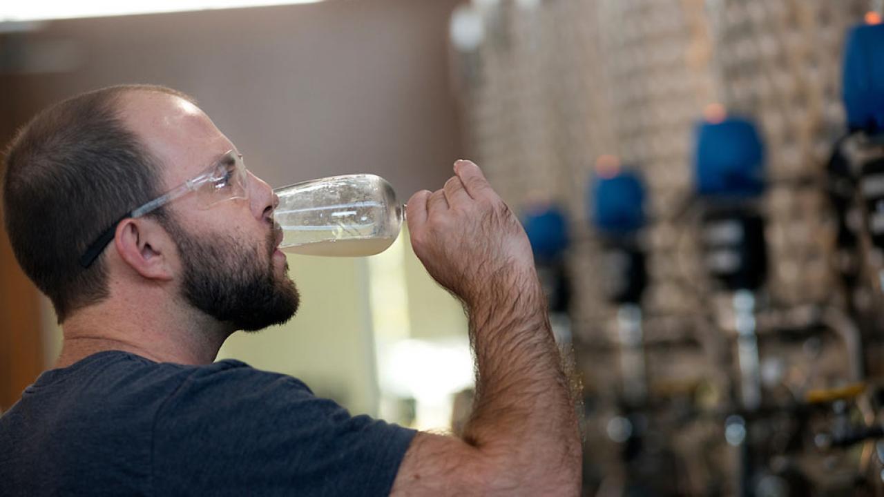 A UC Davis student sips his own ale creation in beer making class