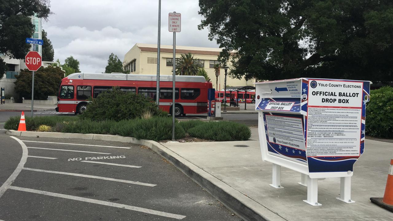 "Official Ballot Drop Box," foreground, Unitrans bus behind