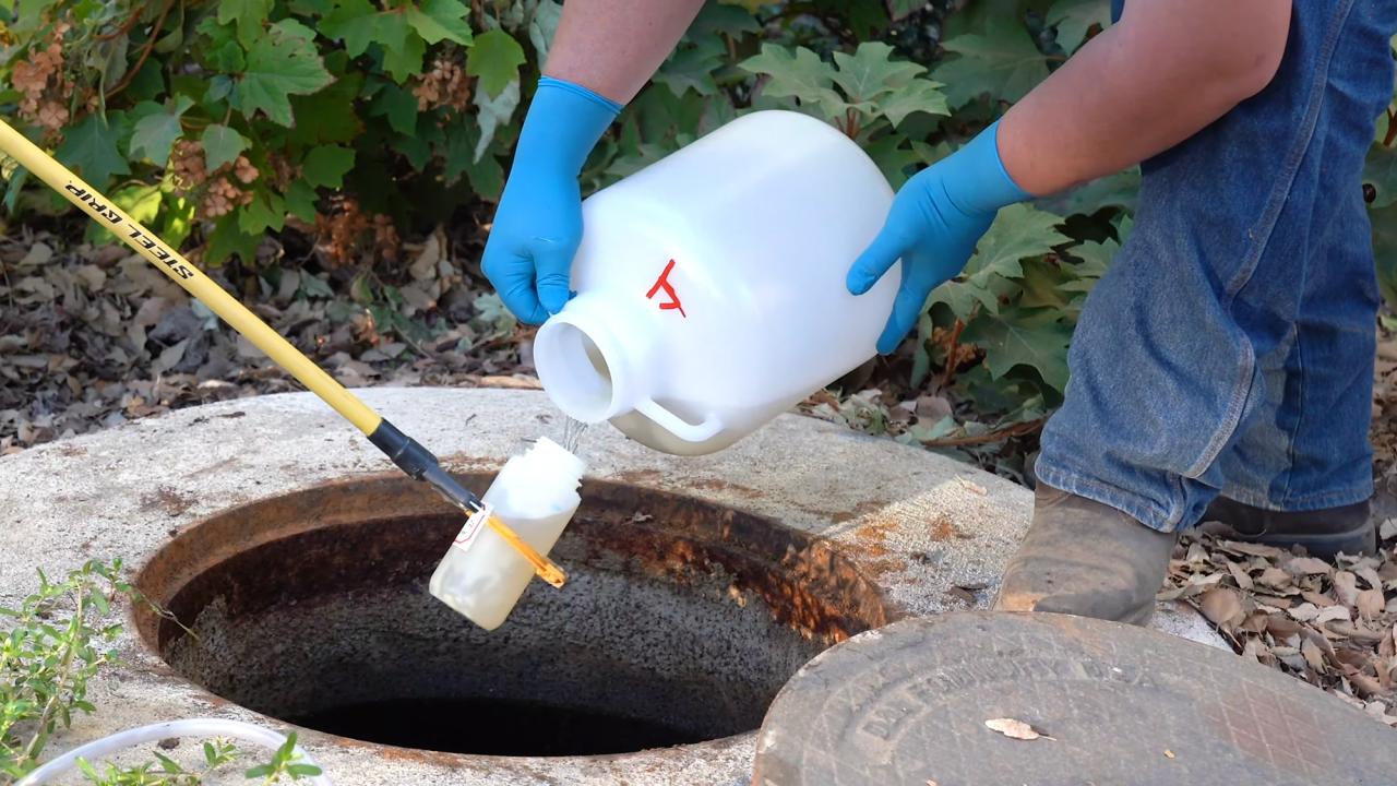 A bottle pouring a water sample into a tube