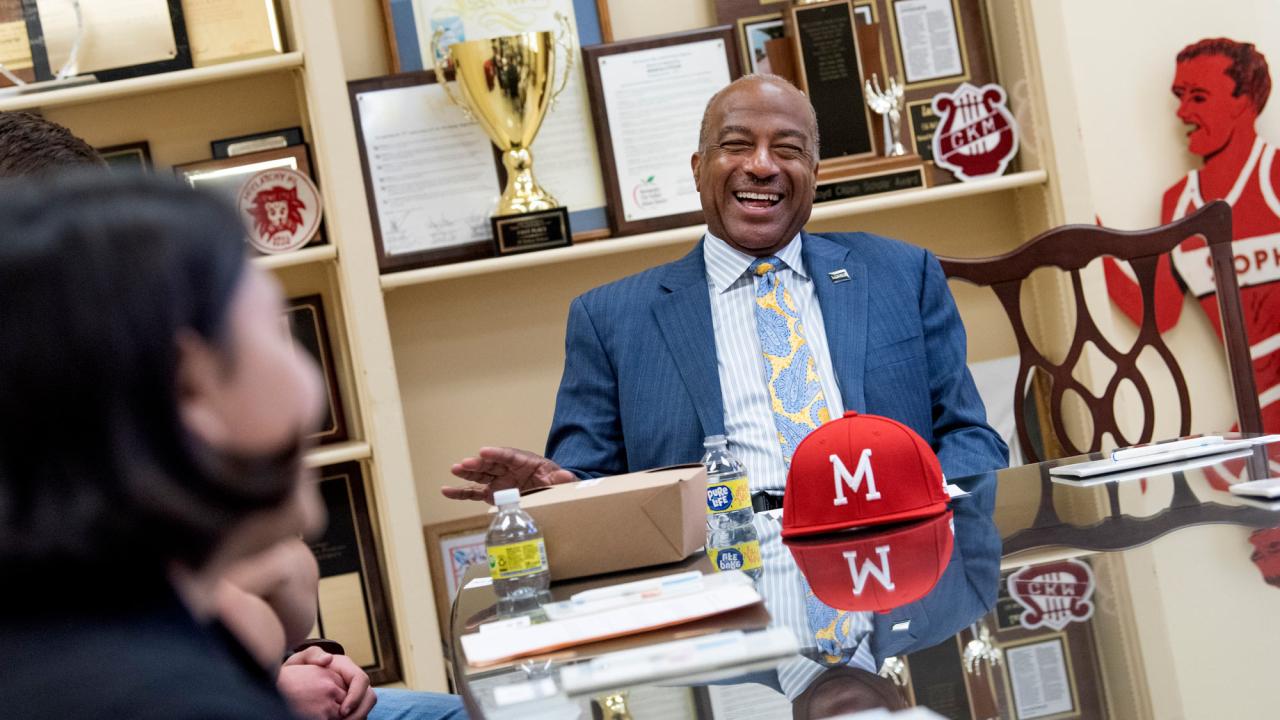 Chancellor Gary S. May sits at a table