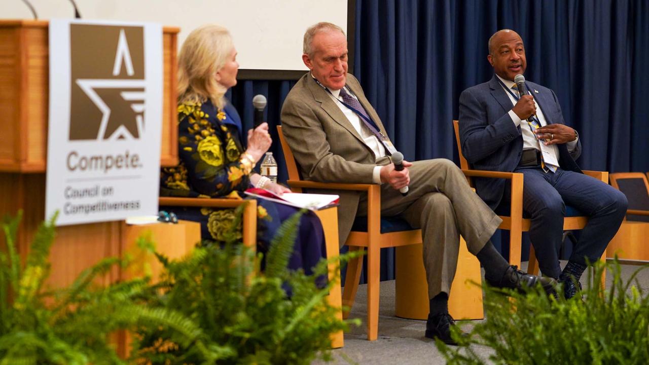 Chancellor Gary S. May on stage with two other people.