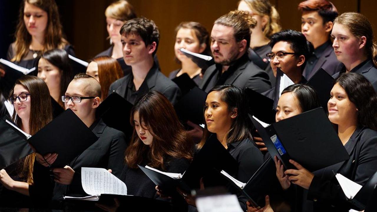 Choristers in black singing at UC Davis event