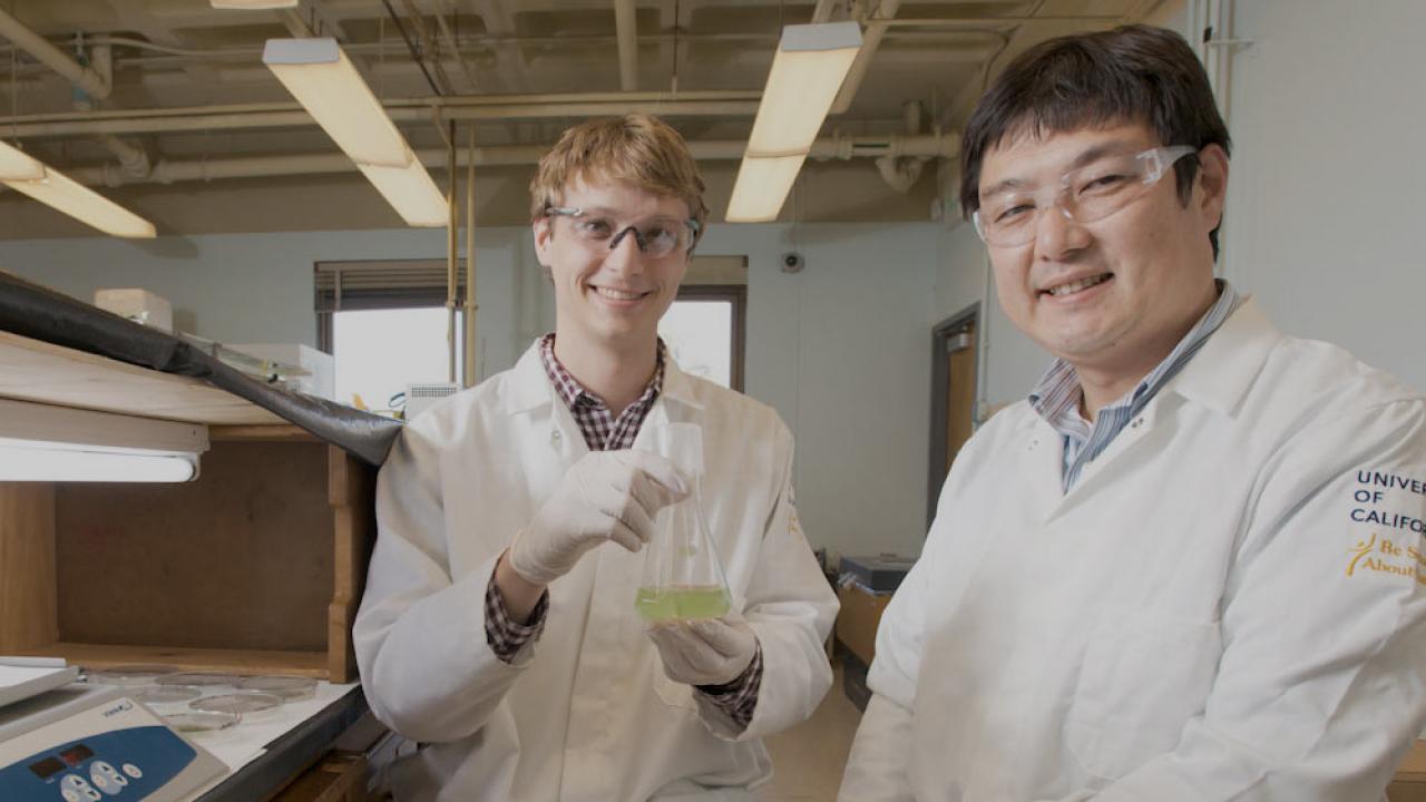 Two male researchers smile for the camera
