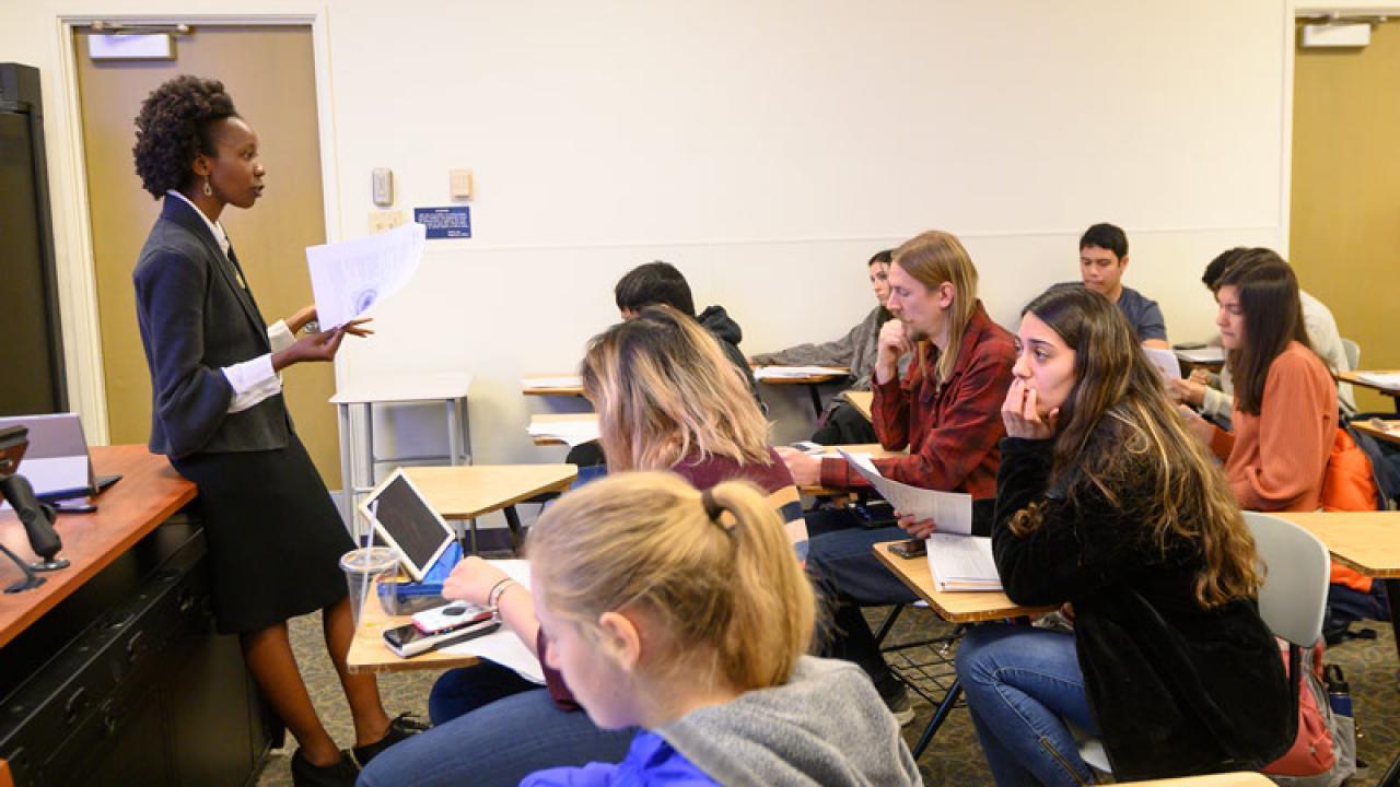 a professor teaching students in a classroom