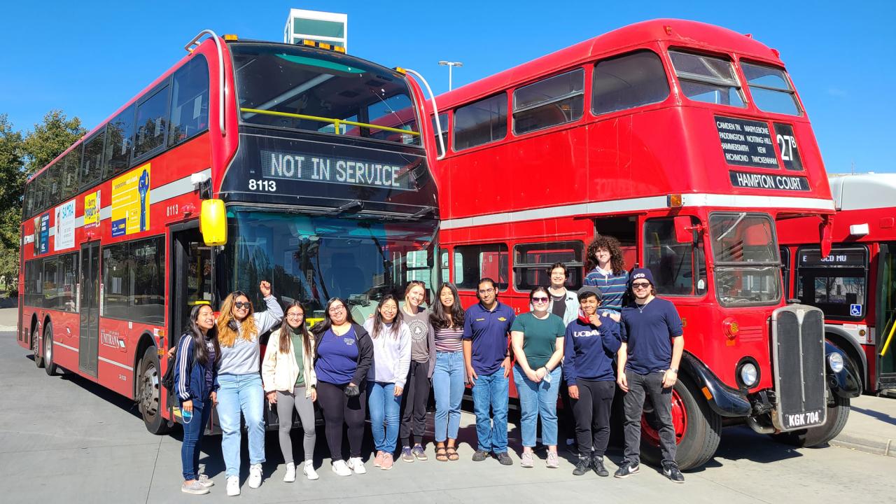 Unitrans drivers and conductors pose in front of double-deckers old and new