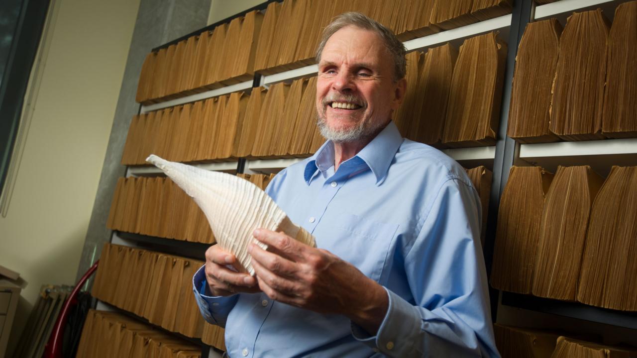 Distinguished Professor Emeritus Geerat Vermeij, portrait, leaning against files, UC Davis faculty