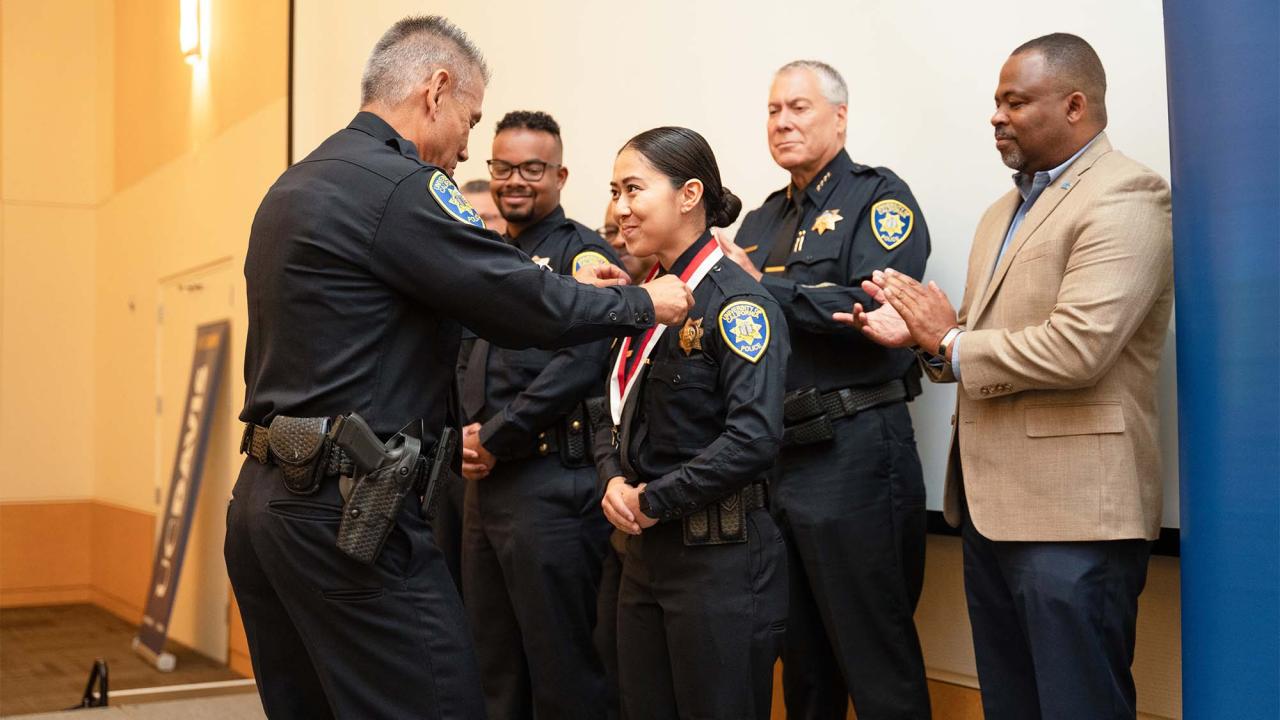 Police Chief Joe Farrow awards medal to police officer