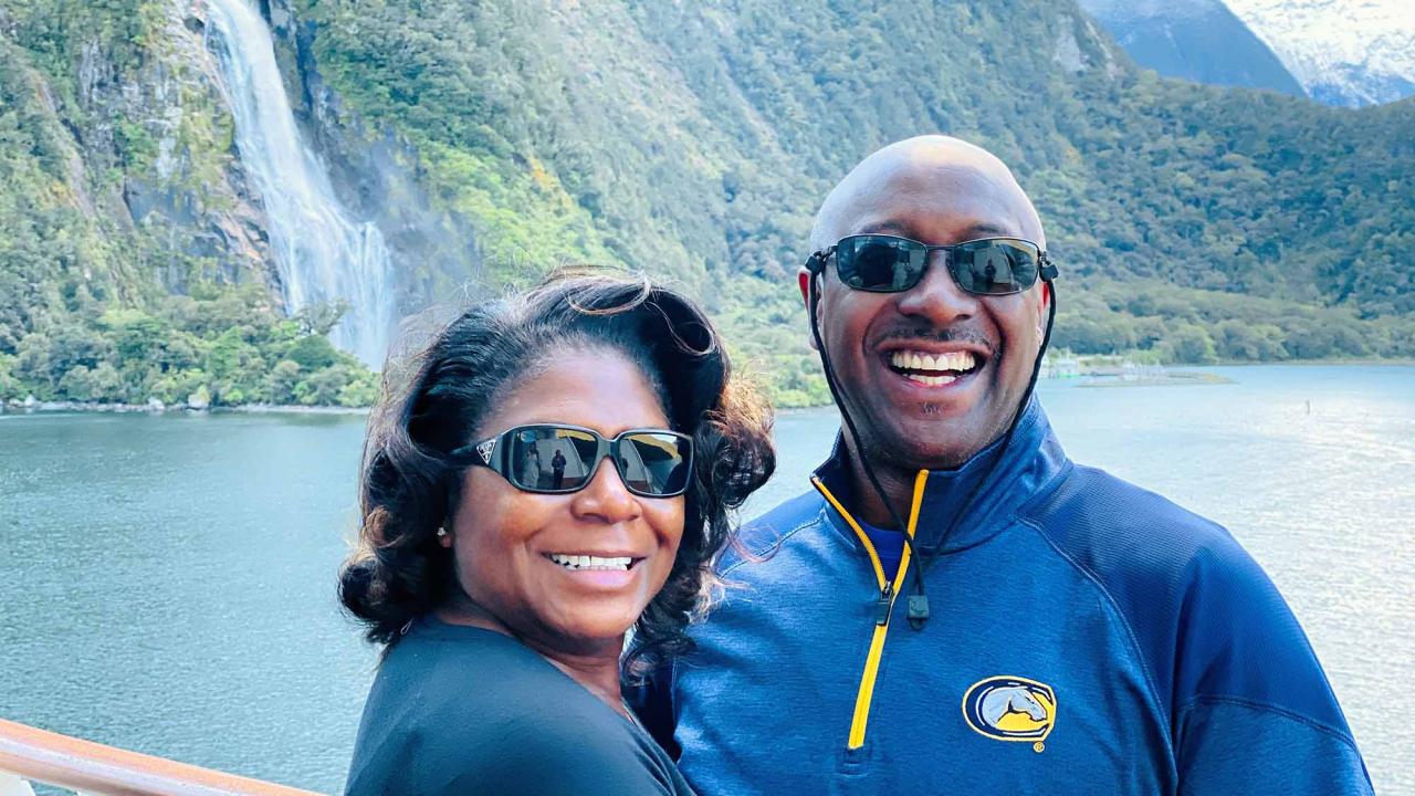 Lois and Darryl Goss outside near a waterfall