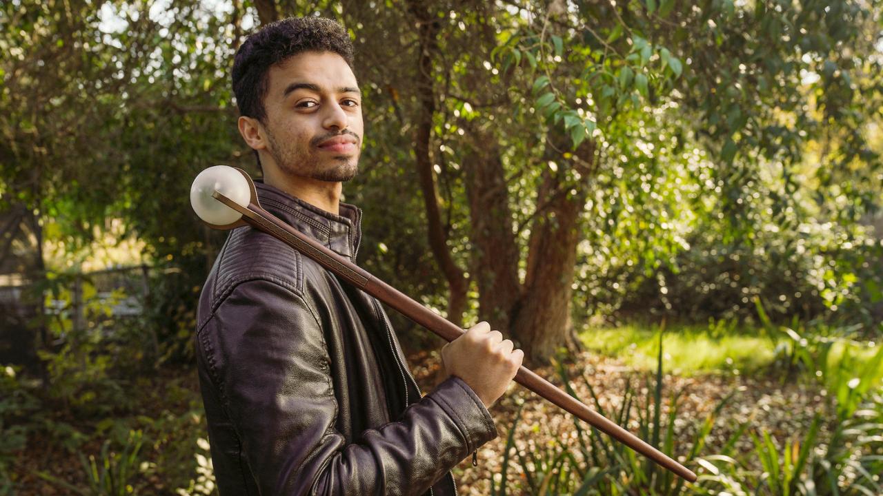 Amir Ali holds the new mace over his shoulder